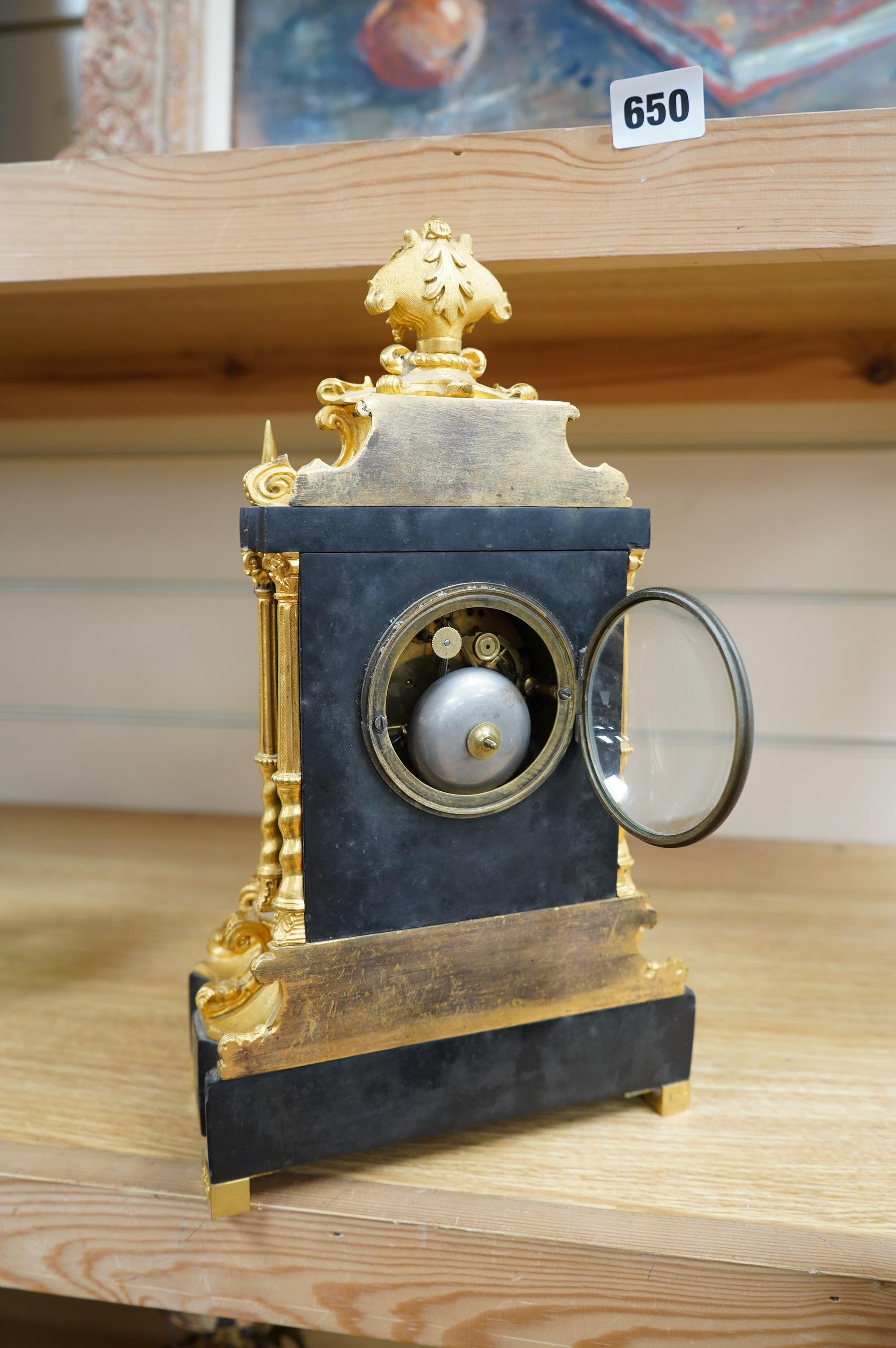 A French ormolu and slate mantle clock with a silk suspension movement, 33cm high. Condition - fair, cracks to the enamel dial.